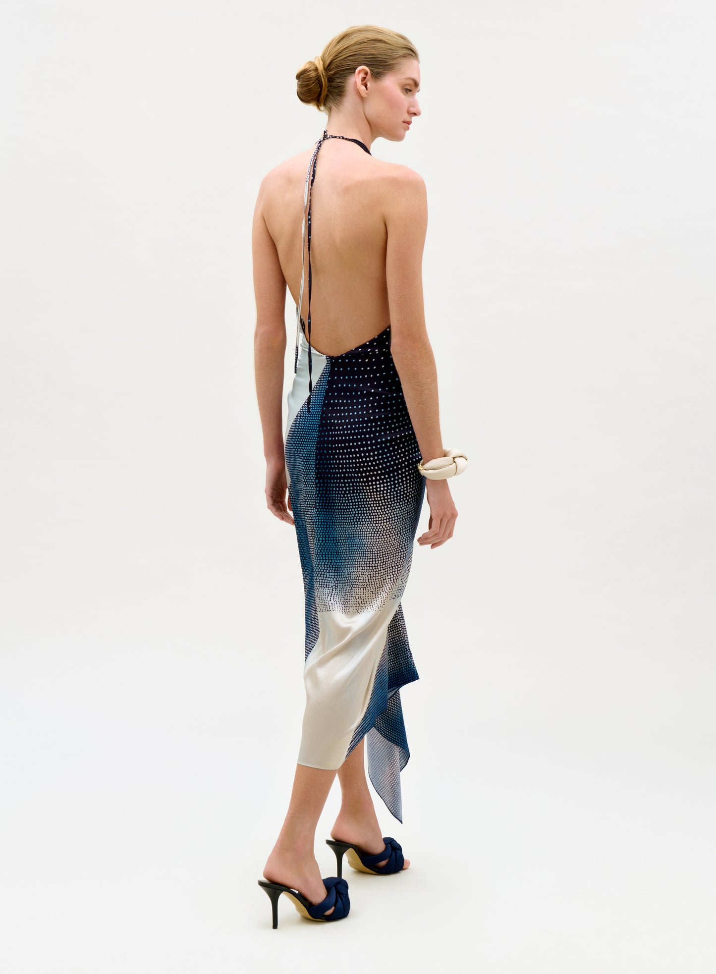 Woman wearing a stylish dress with a gradient design on a white background