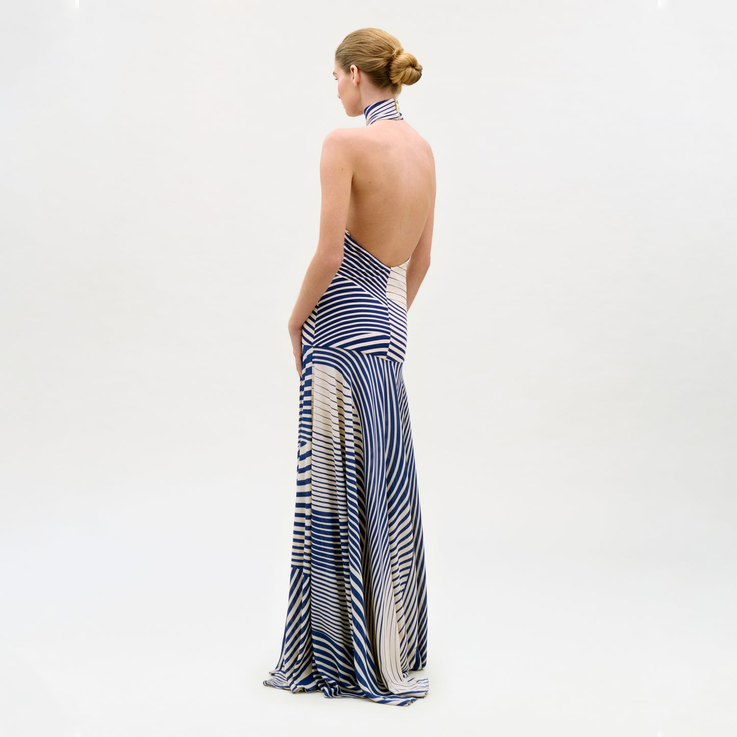 Woman wearing a blue and white striped dress on a white background
