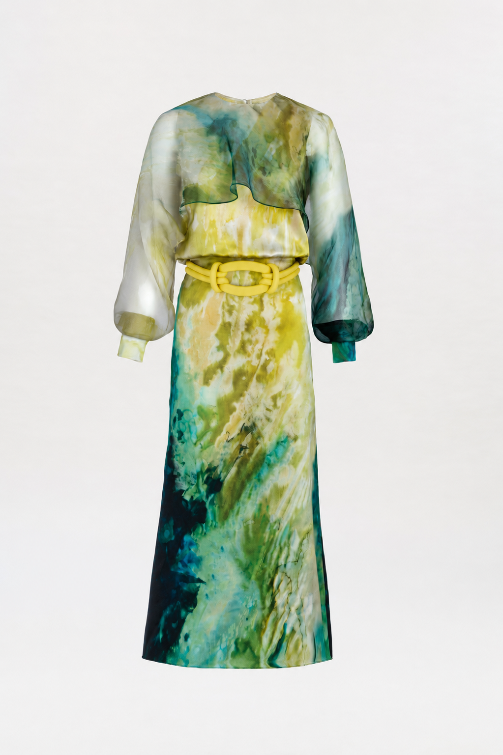 The Rubina Dress is a long-sleeved, ankle-length dress showcasing a watercolor pattern in green, yellow, and blue hues, complete with sheer upper sleeves and accented by a wide yellow belt.
