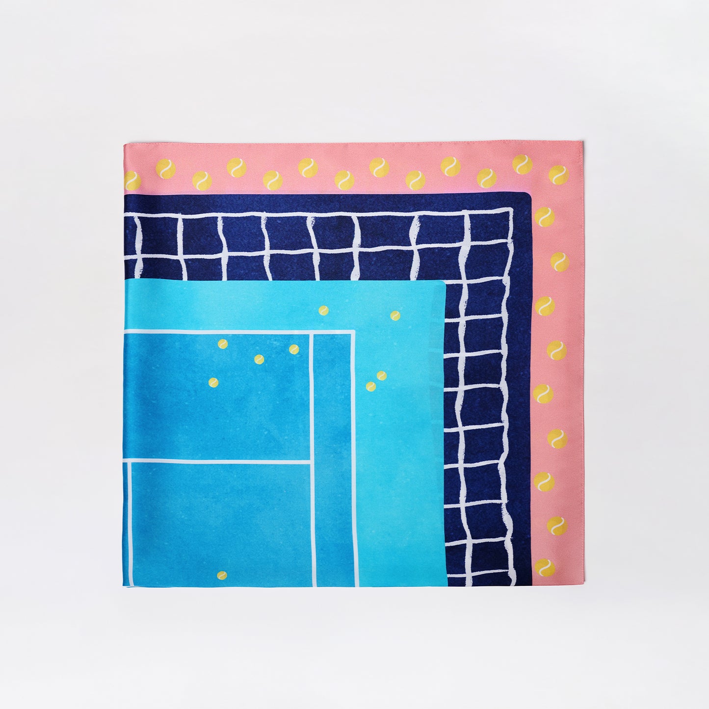 The Tennis Scarf is a square, colorful scarf with a blue tennis court design, navy grid pattern, and a pink border accented by yellow tennis balls. Background is plain white.