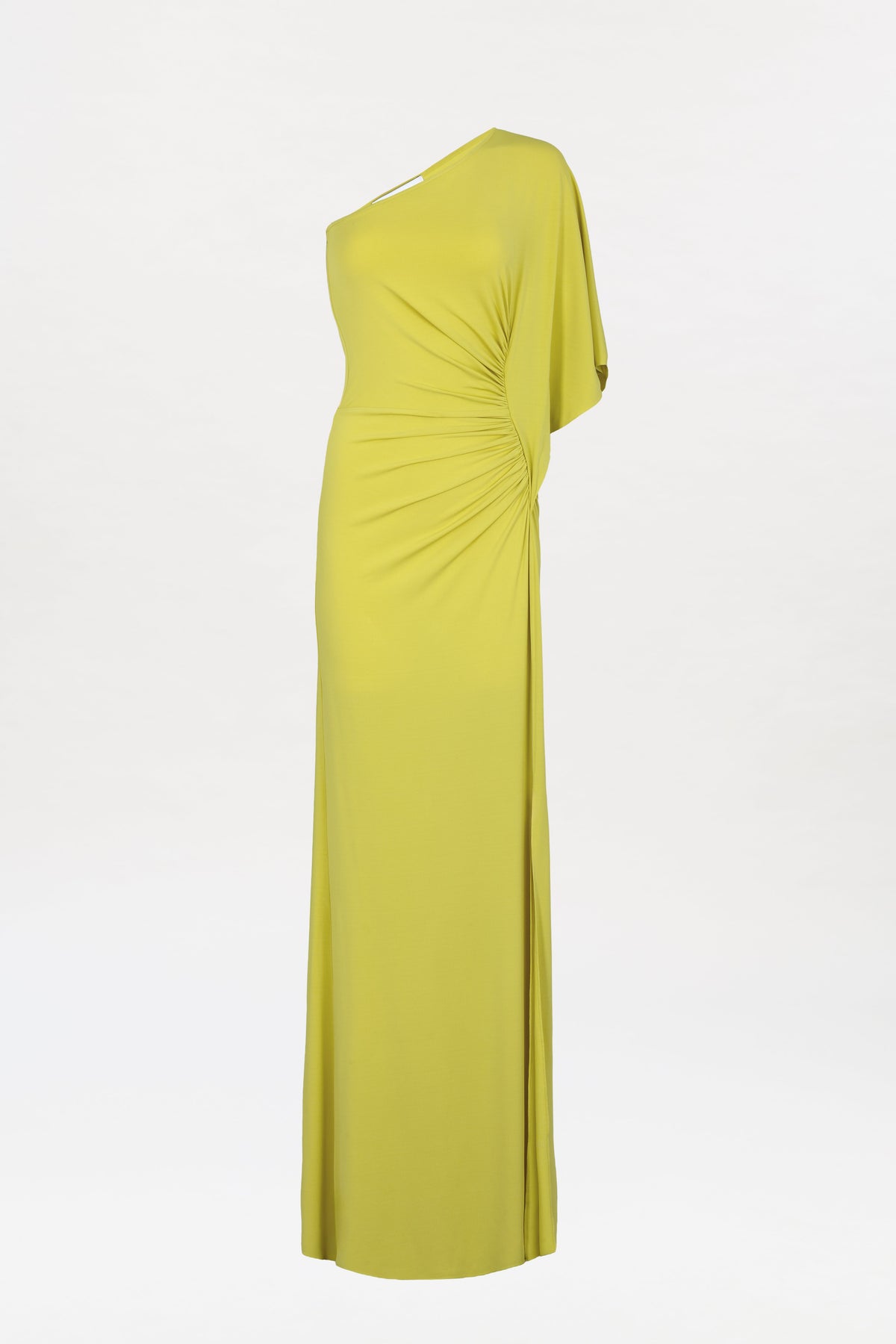 The Doli Dress is a long, yellow-green one-shoulder gown featuring ruched detailing at the waist, draped fabric, and a floor-length hem, shown against a plain white background.