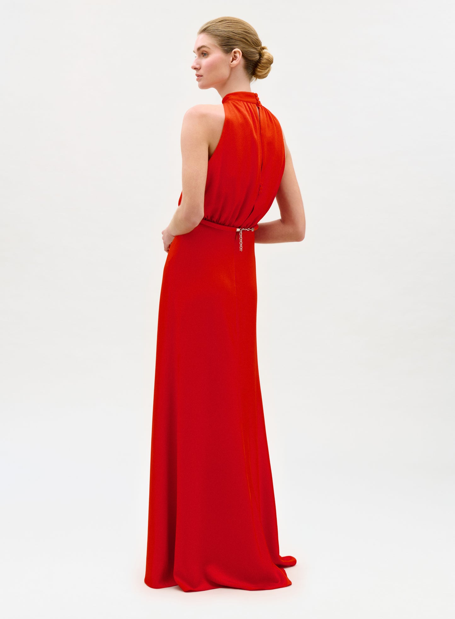 Woman wearing a red evening gown on a white background