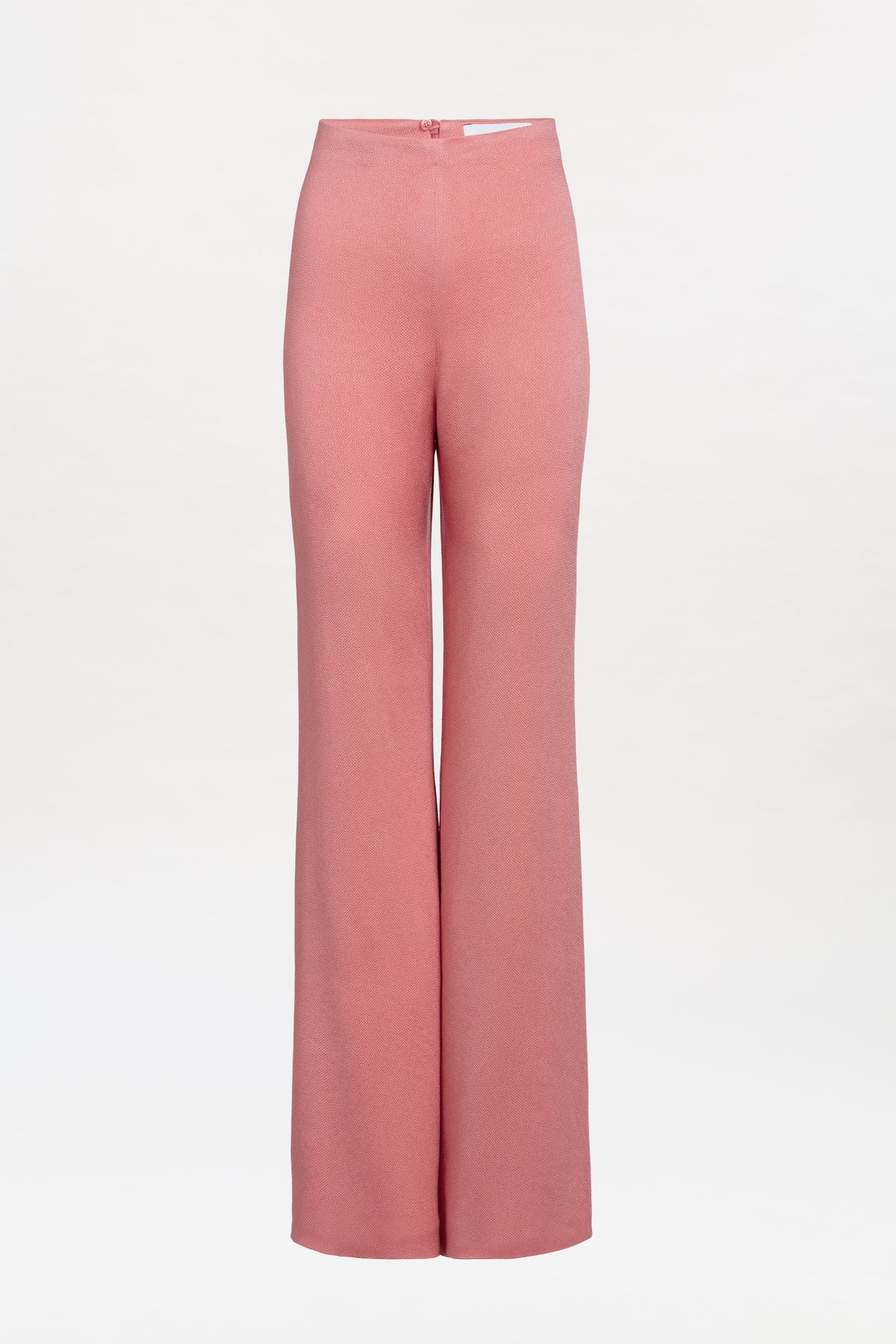 The Palermo Pant is a high-waisted, wide-leg pink trouser showcased against a plain white background. It features a smooth texture and a fitted waist with a back zipper closure.