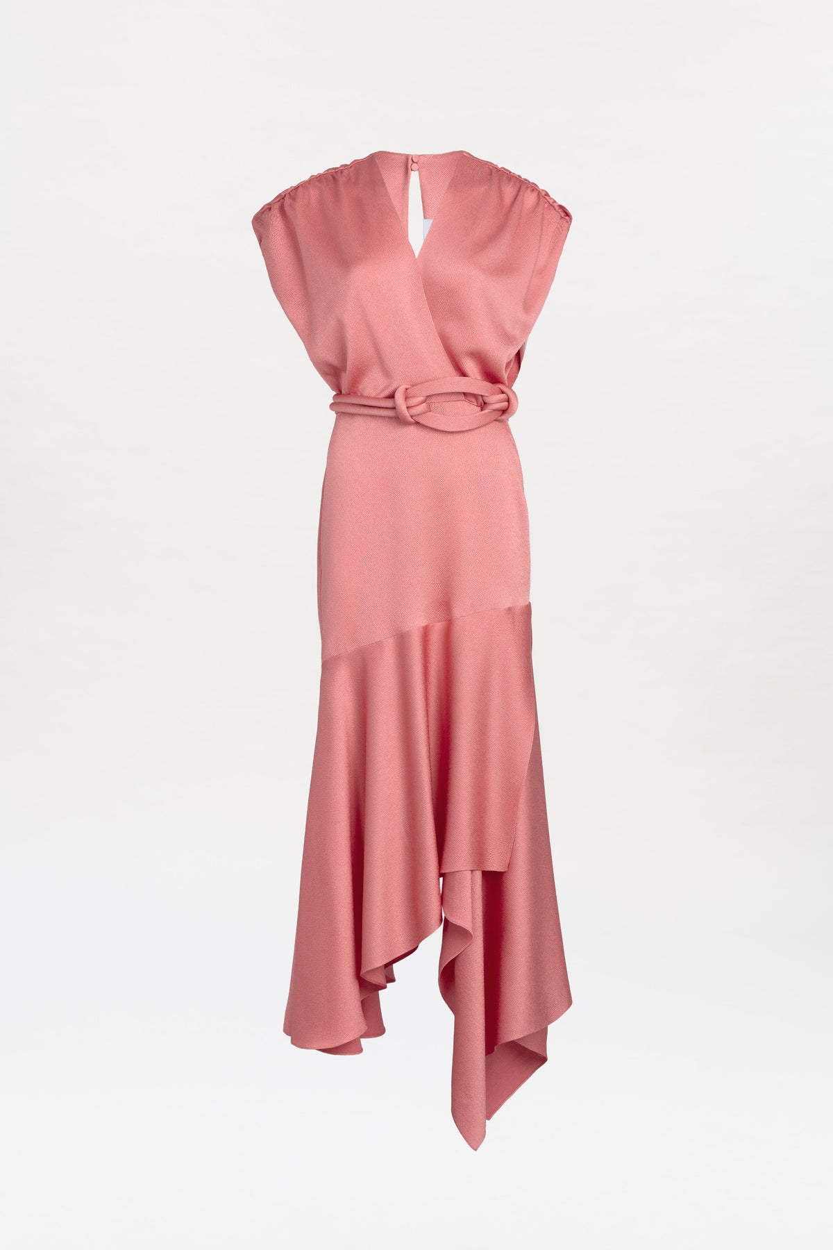 Introducing the Protea Dress: a sleeveless pink dress featuring a V-neckline, belted waist, and an asymmetrical hemline. Its soft fabric drapes elegantly, creating a flowing silhouette against a plain white background.