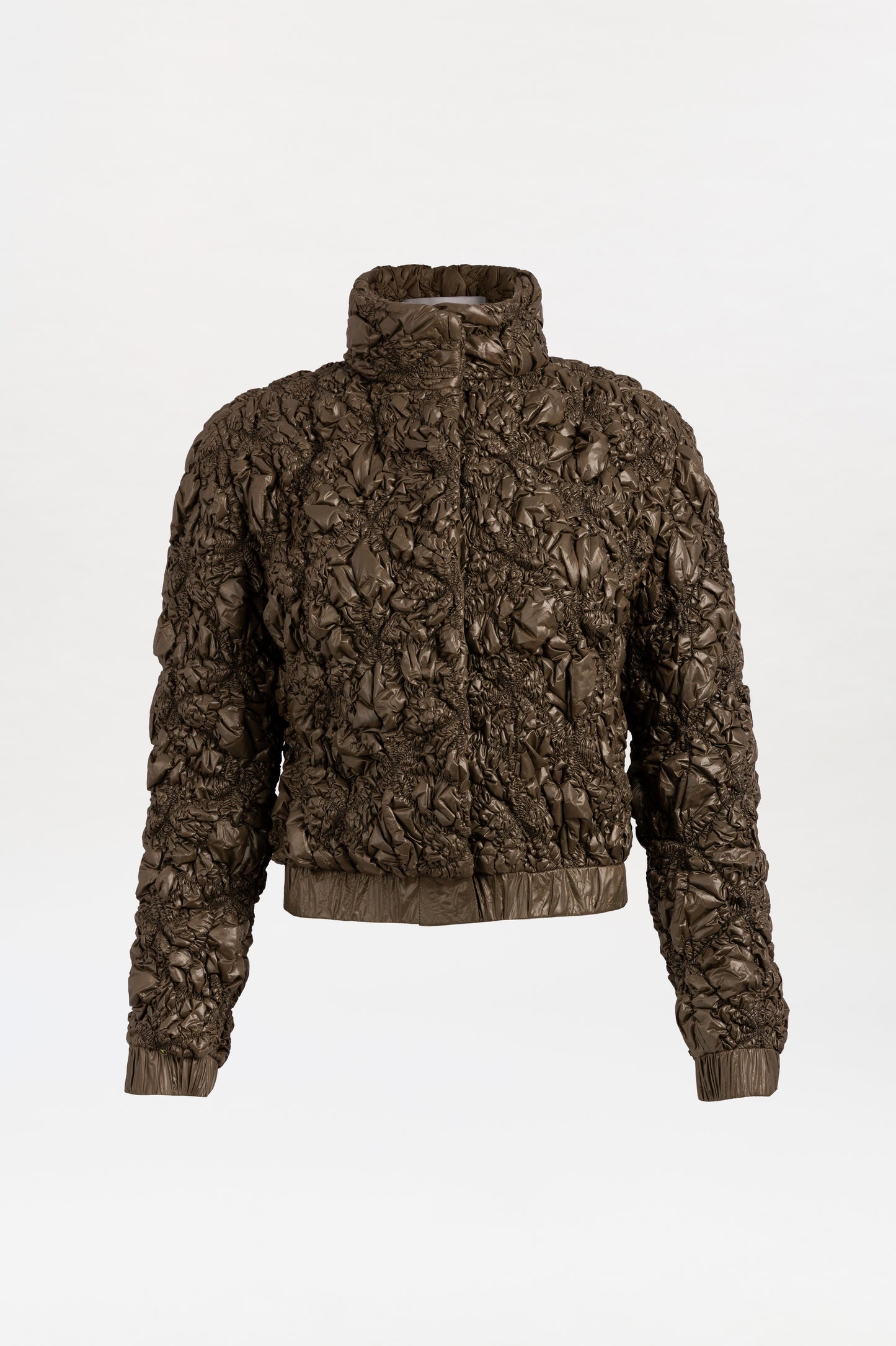 The Zalta Jacket, a brown puffer with a textured finish, features a high collar and elastic cuffs, shown on a plain white background.