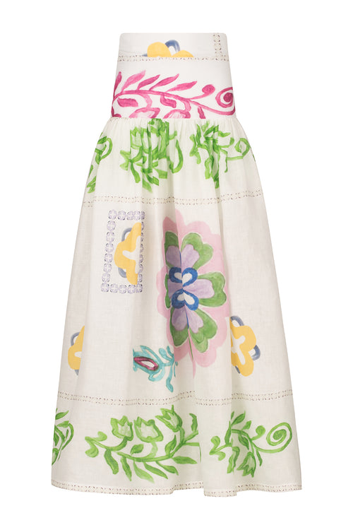 A woman wearing an Abla Skirt Multicolor Floral Print with abstract floral designs.