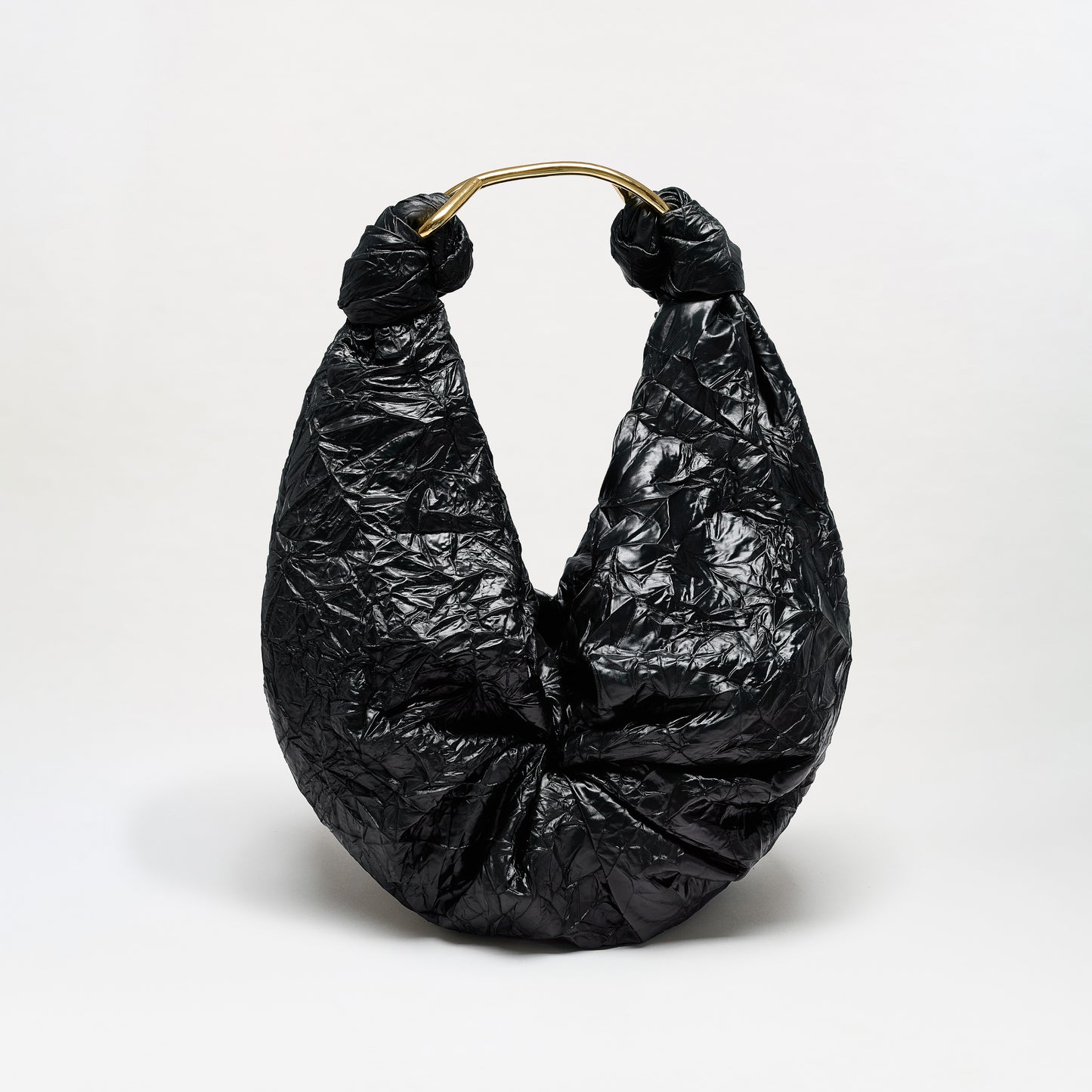 The Sofia Bag (Maxi) is a black, crinkled hobo-style maxi bag featuring a gold-toned handle and crafted from luxurious Italian fabric, displayed against a plain white background.