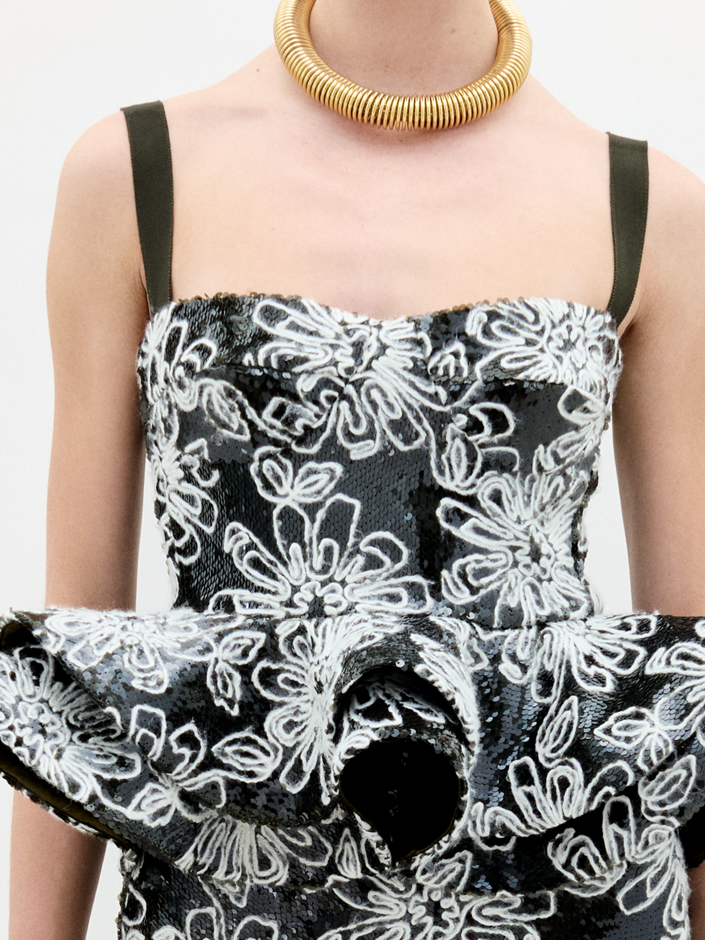 A woman wearing the Adriana Top black an white on a white background.