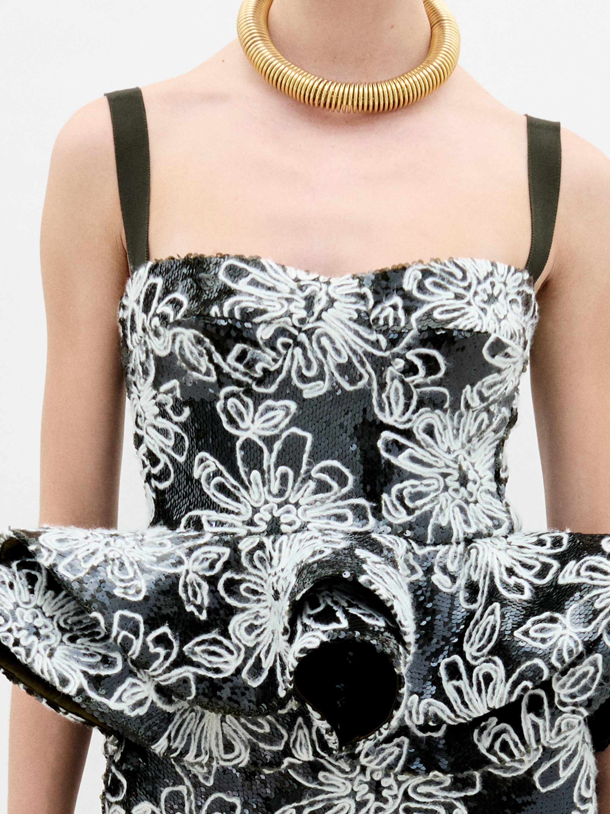 A woman wearing the Adriana Top black an white on a white background.