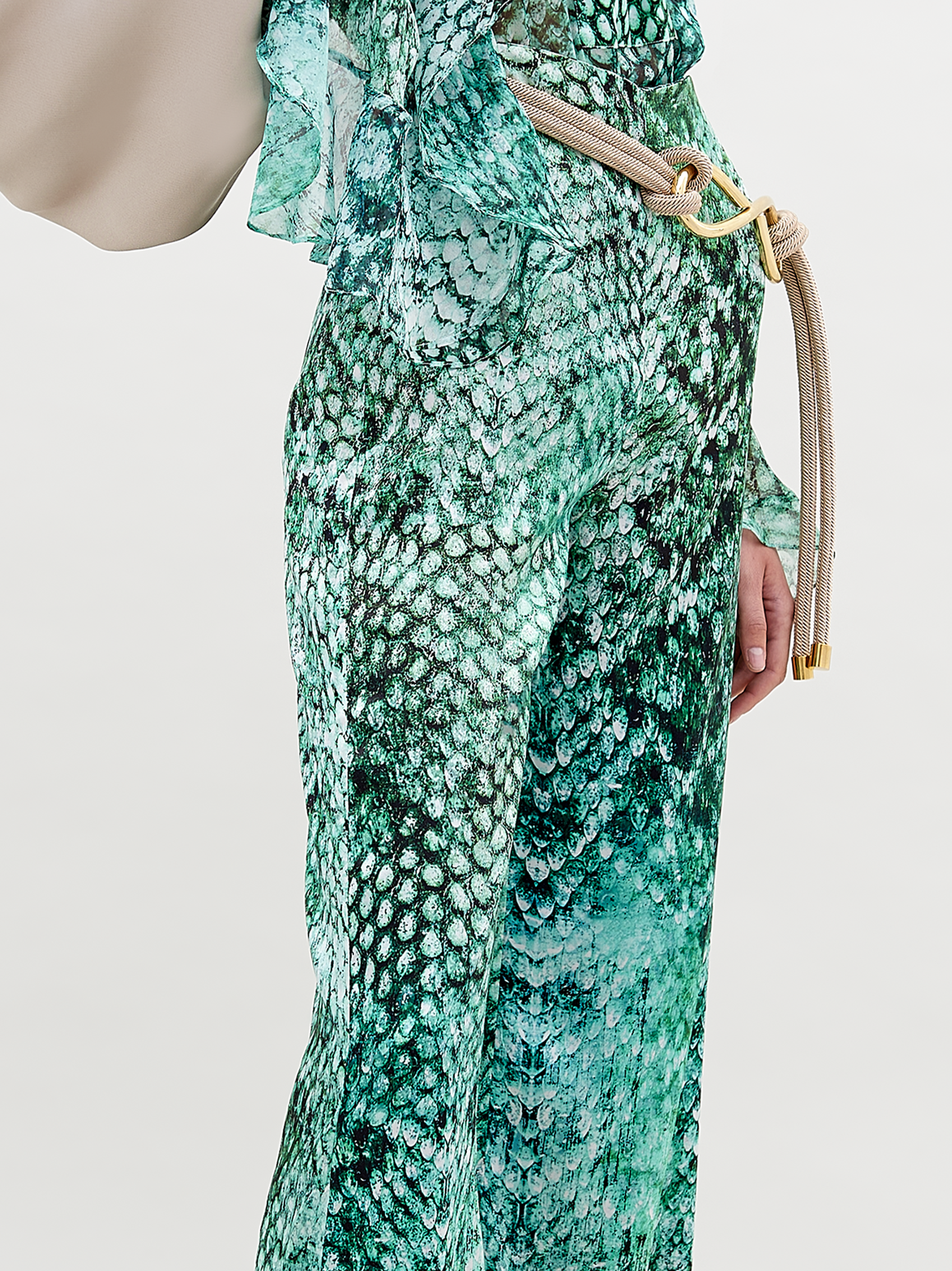 A person stands against a plain background wearing the Andie pant