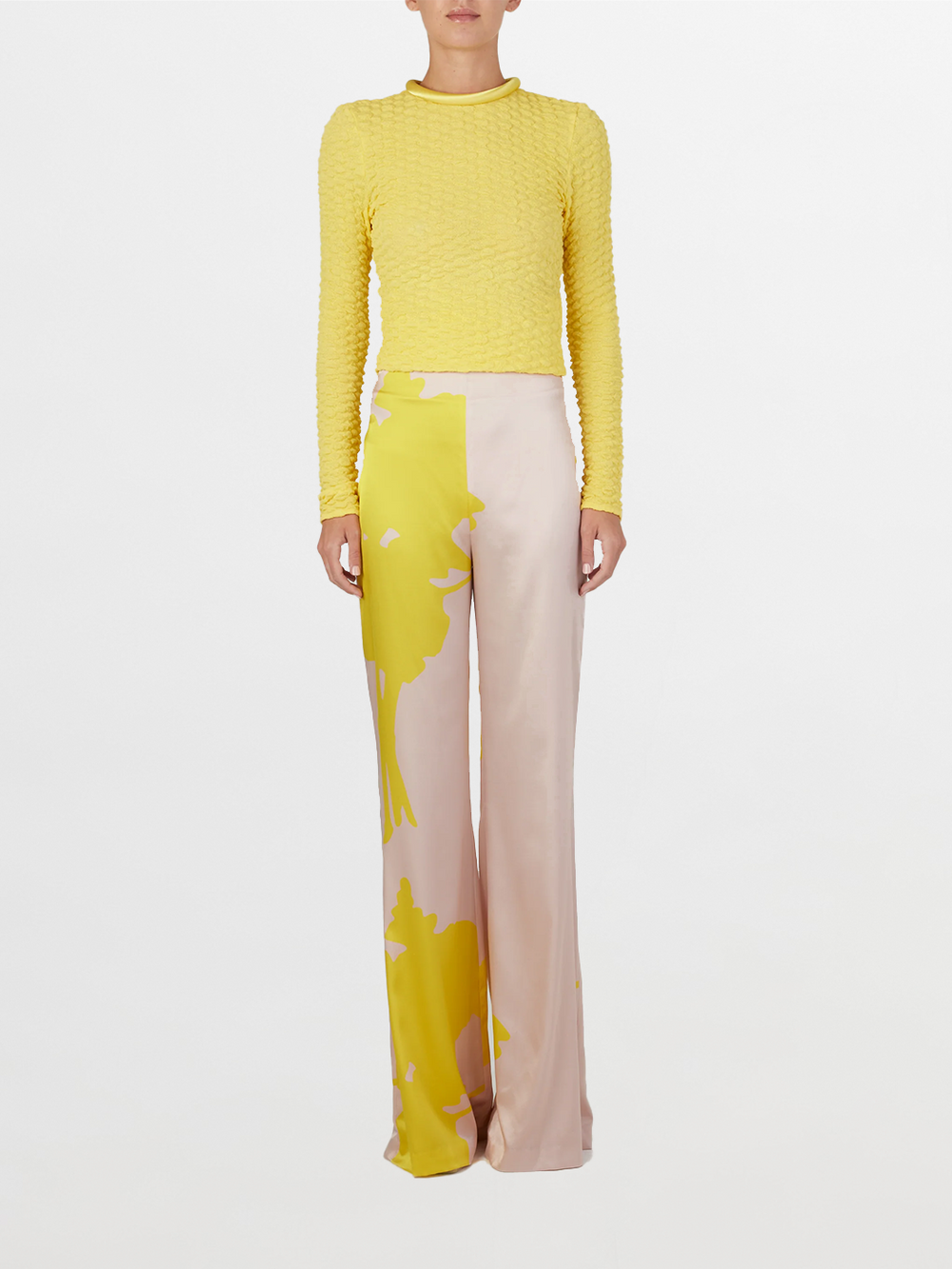 A versatile, long-sleeved Jari Top Yellow with a ruffled neckline made from embossed jacquard fabric.