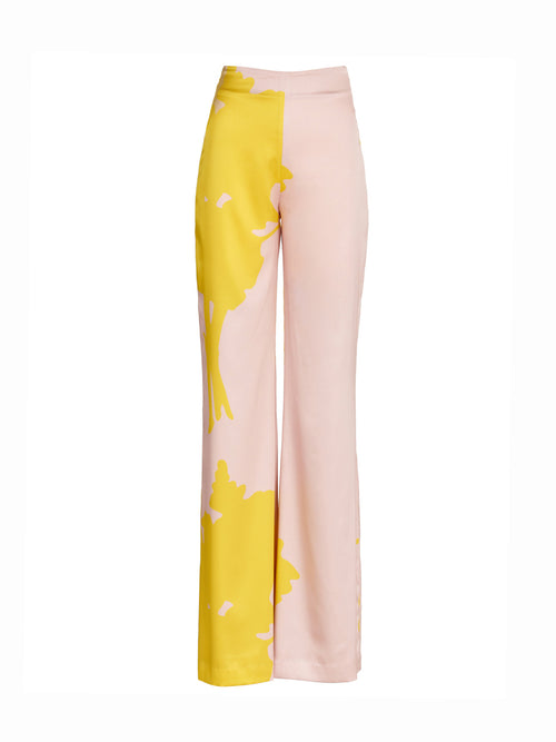 A pair of pink and yellow Andie Pant Yellow Nude Floral, wide-legged and high-waisted.