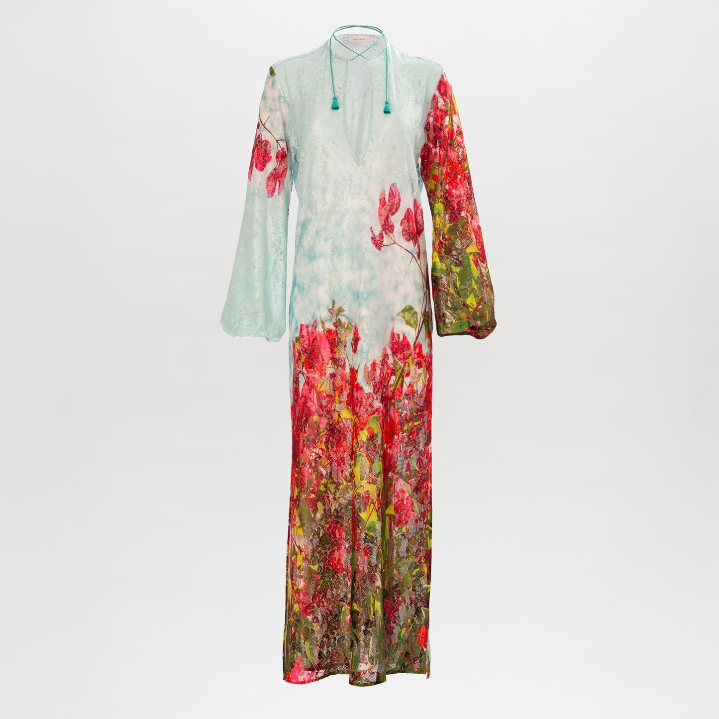 The Mayfair Tunic is a long, sheer dress featuring a light blue top, floral print, long sleeves, and a keyhole neckline with tie detail.