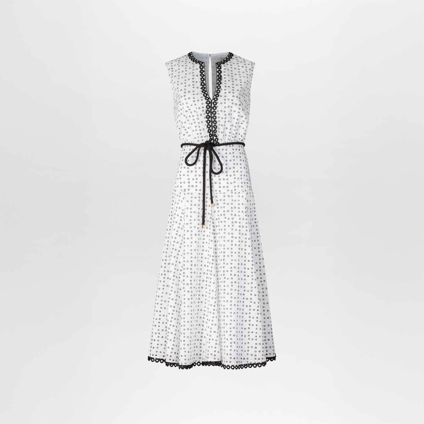 The model is wearing a Bora Dress White Black Dots.