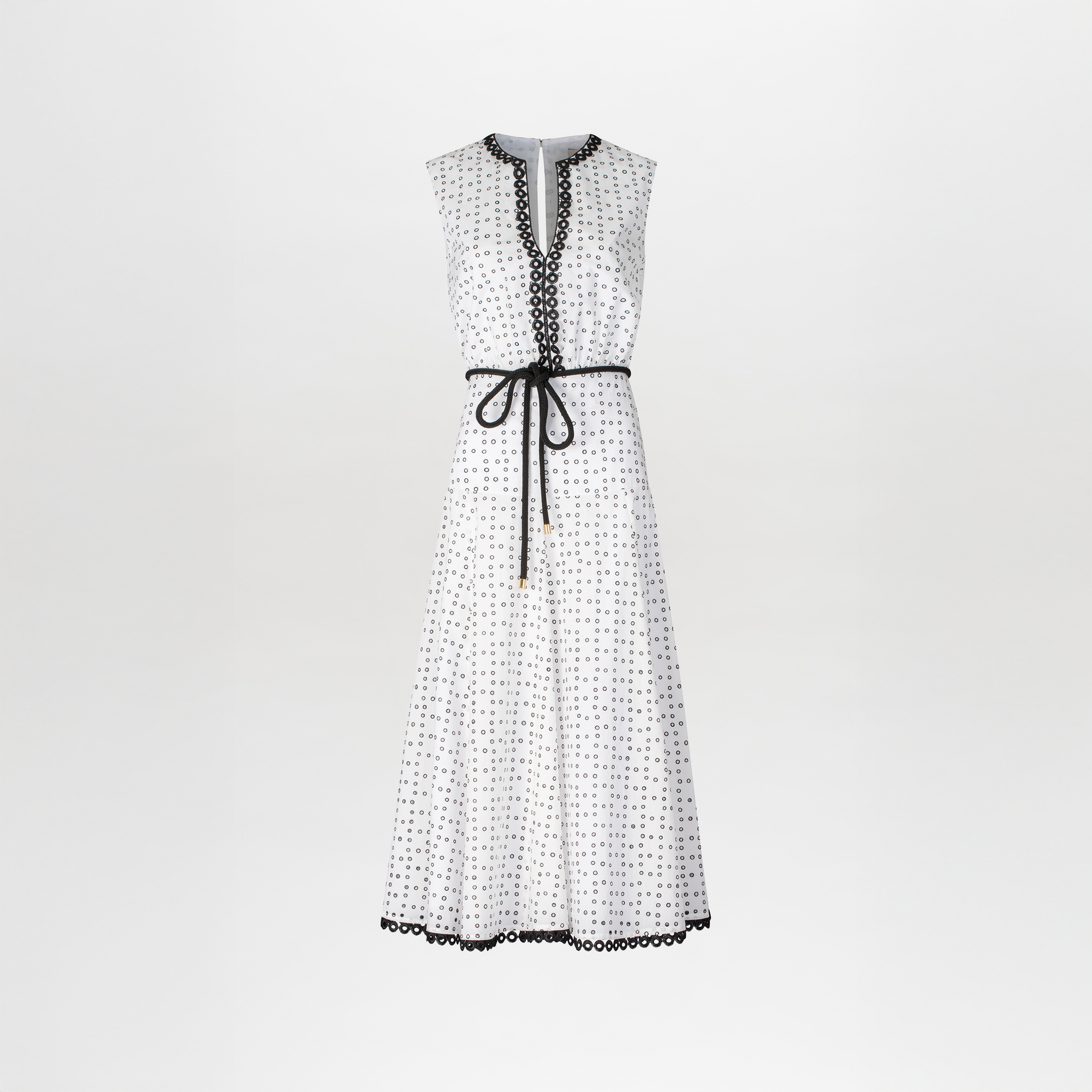 The model is wearing a Bora Dress White Black Dots.