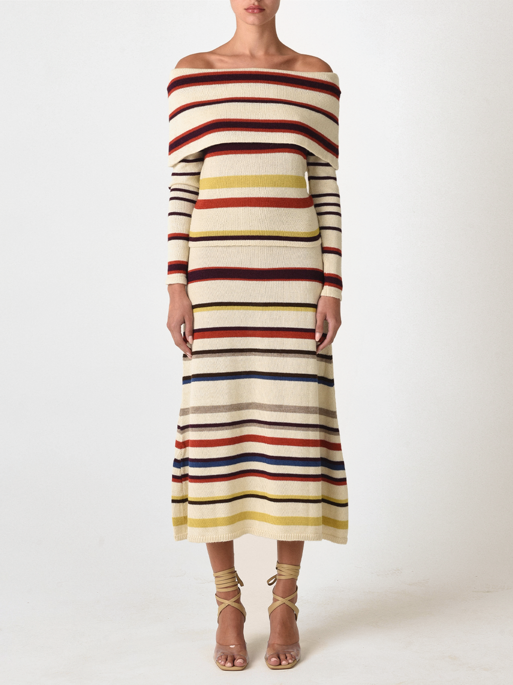 A person wearing the Brie Skirt in Multi Mustard Stripe, paired with strappy sandals, enjoys the comfort of sustainably dyed fabric.