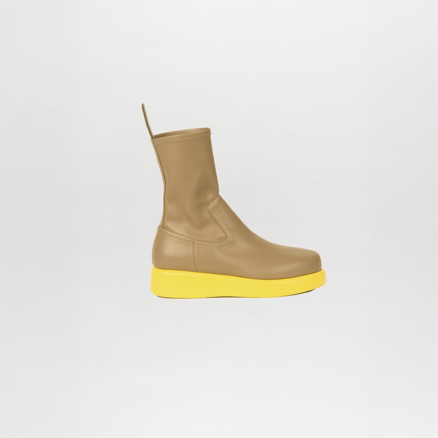 The Baia Boots Taupe Lemon features soft stretch calf leather in taupe, a pull tab, and a thick lemon-yellow sole for a bold, fashion-forward look against a plain white background.