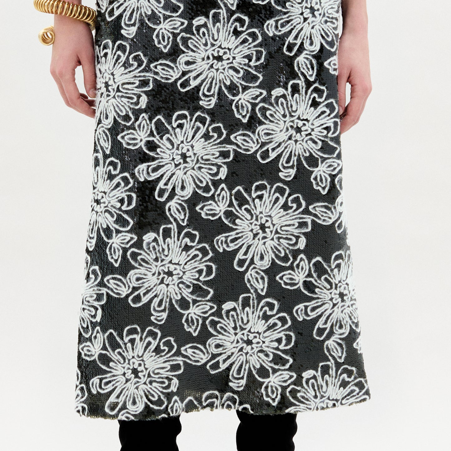 A person stands against a plain background wearing the Blair Skirt