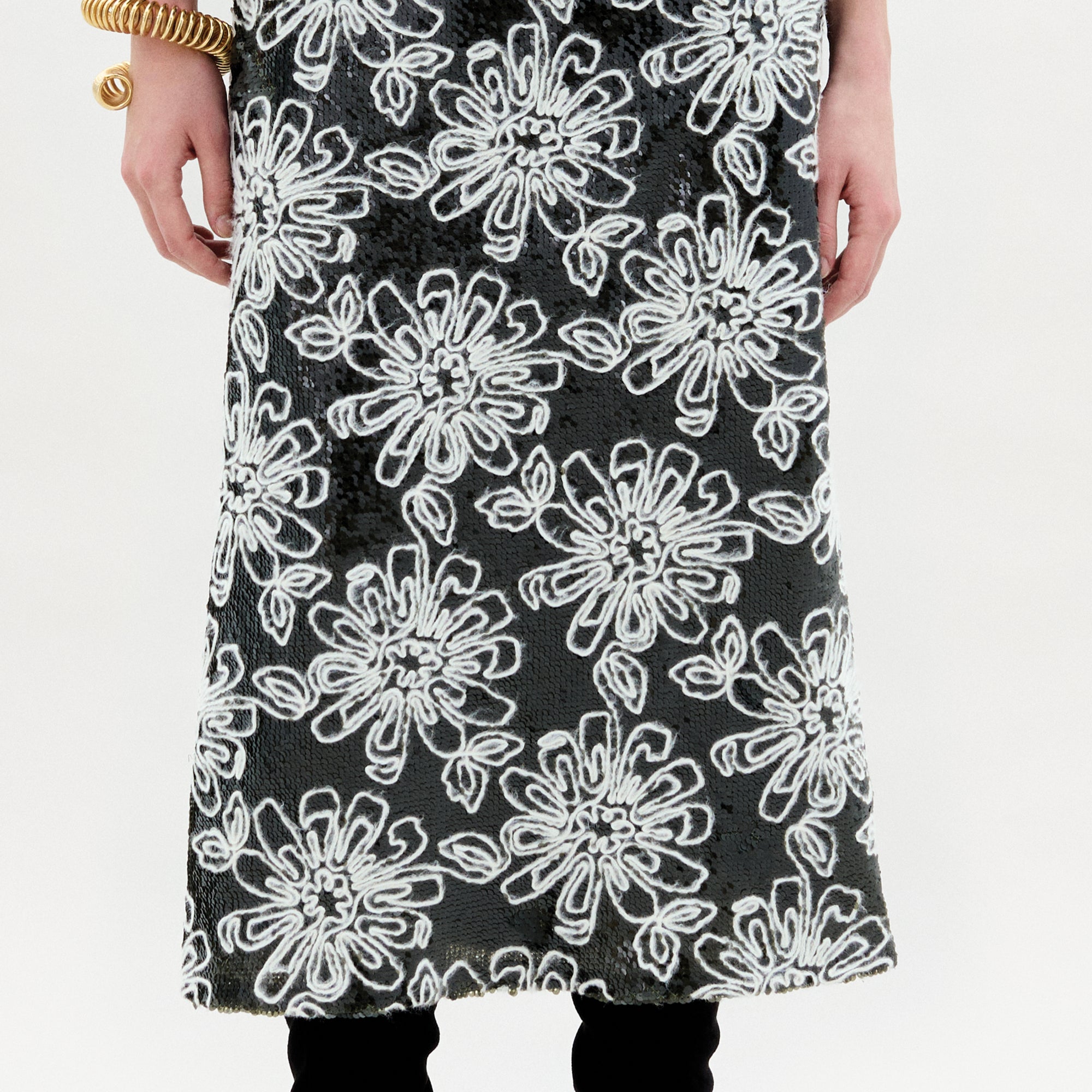 A person stands against a plain background wearing the Blair Skirt