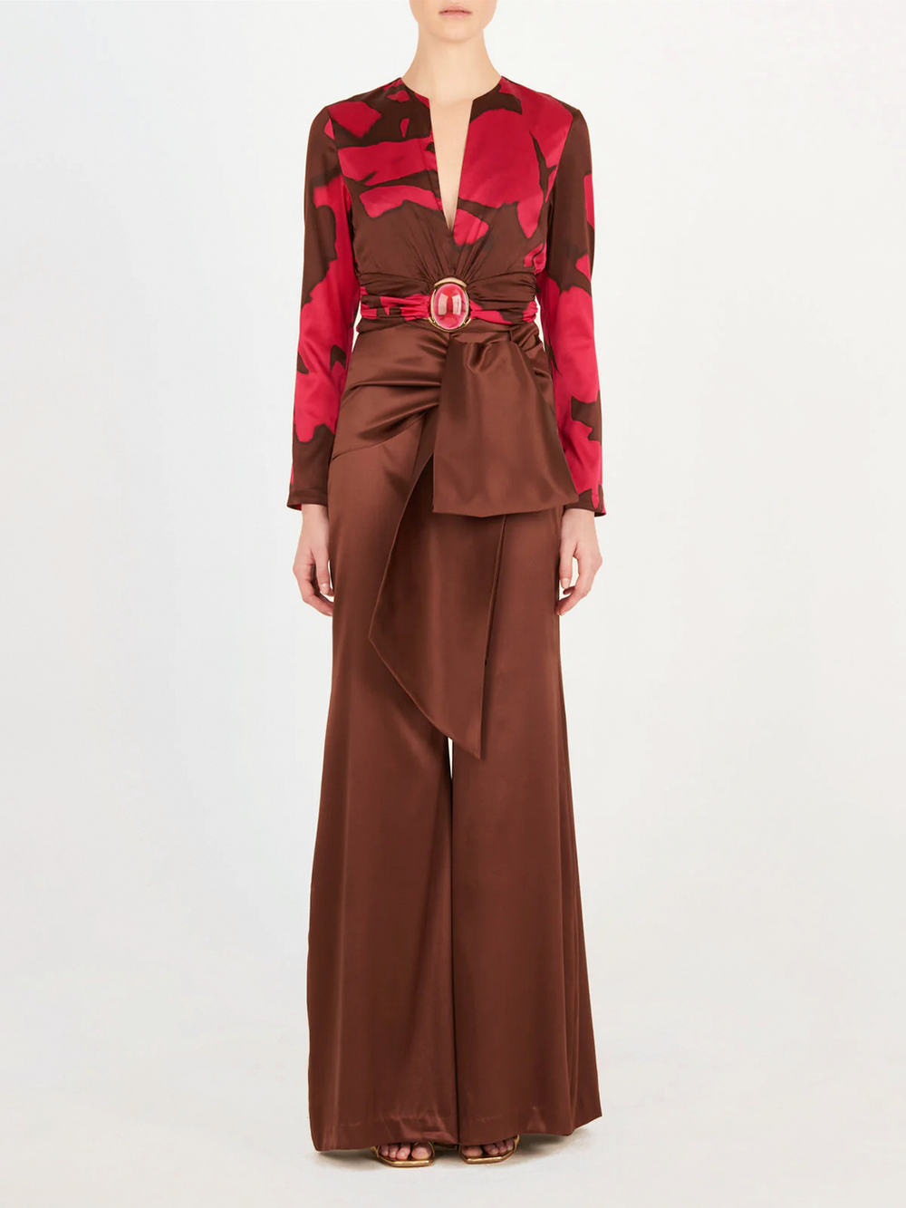 A pink and brown Edith Blouse Fuchsia Cacao with a belt, featuring an Italian resin detail.