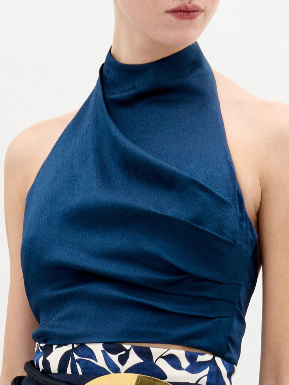 A person wearing the Colima Top in color Navy Elliot on a white background.