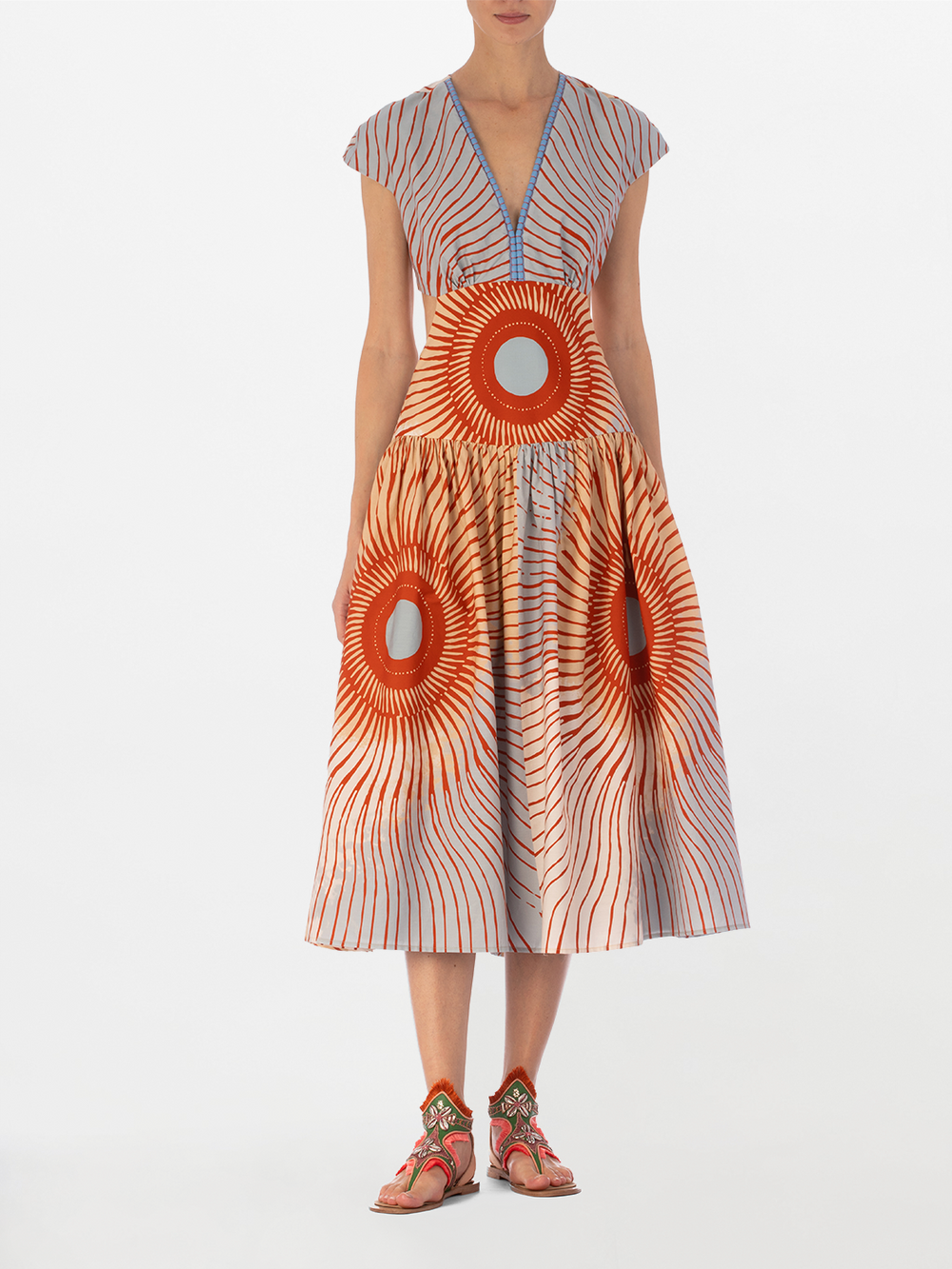 Displayed on the mannequin is the enchanting Cecile Dress Sausalito Sunset, featuring exquisite cutout details and a vibrant multicolor pattern that is sure to turn heads.
