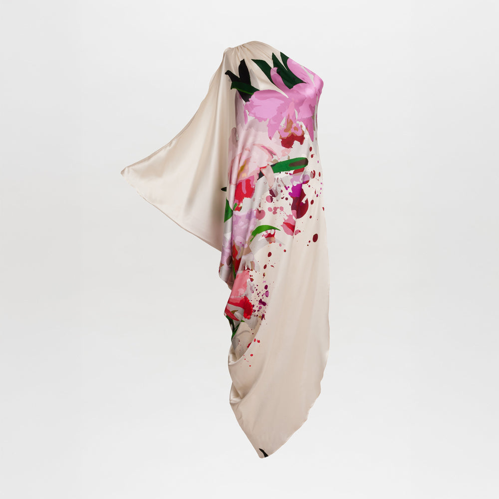 The Chiara Dress features cream-colored draped fabric adorned with vibrant pink, green, and red floral prints, displayed against a plain white background—ideal inspiration for those seeking elegant fashion style.
