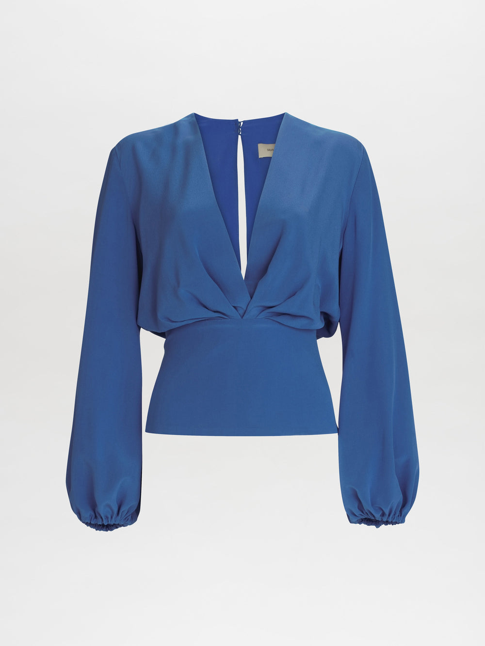 The Delfina Blouse features a deep V-neckline, cinched waist, and long, balloon sleeves in blue.