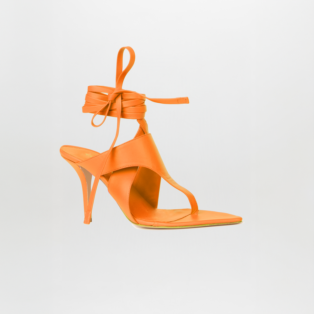 The Domenico Heels Orange by GIA Couture are orange Italian leather sandals featuring a high heel, open toe, square sole, and ankle wrap laces, showcased on a plain white background.
