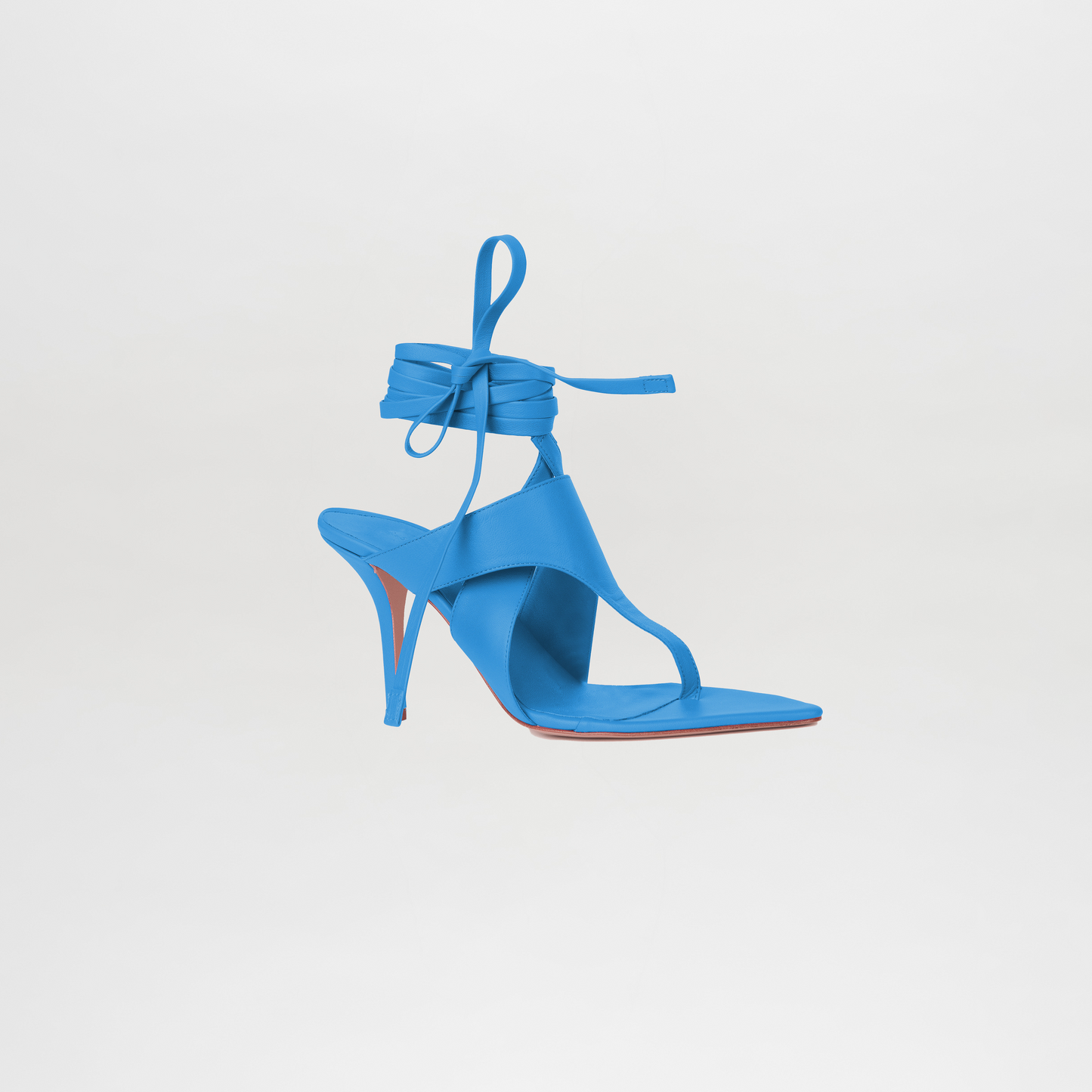 Blue high-heeled sandal with ankle strap on a light gray background