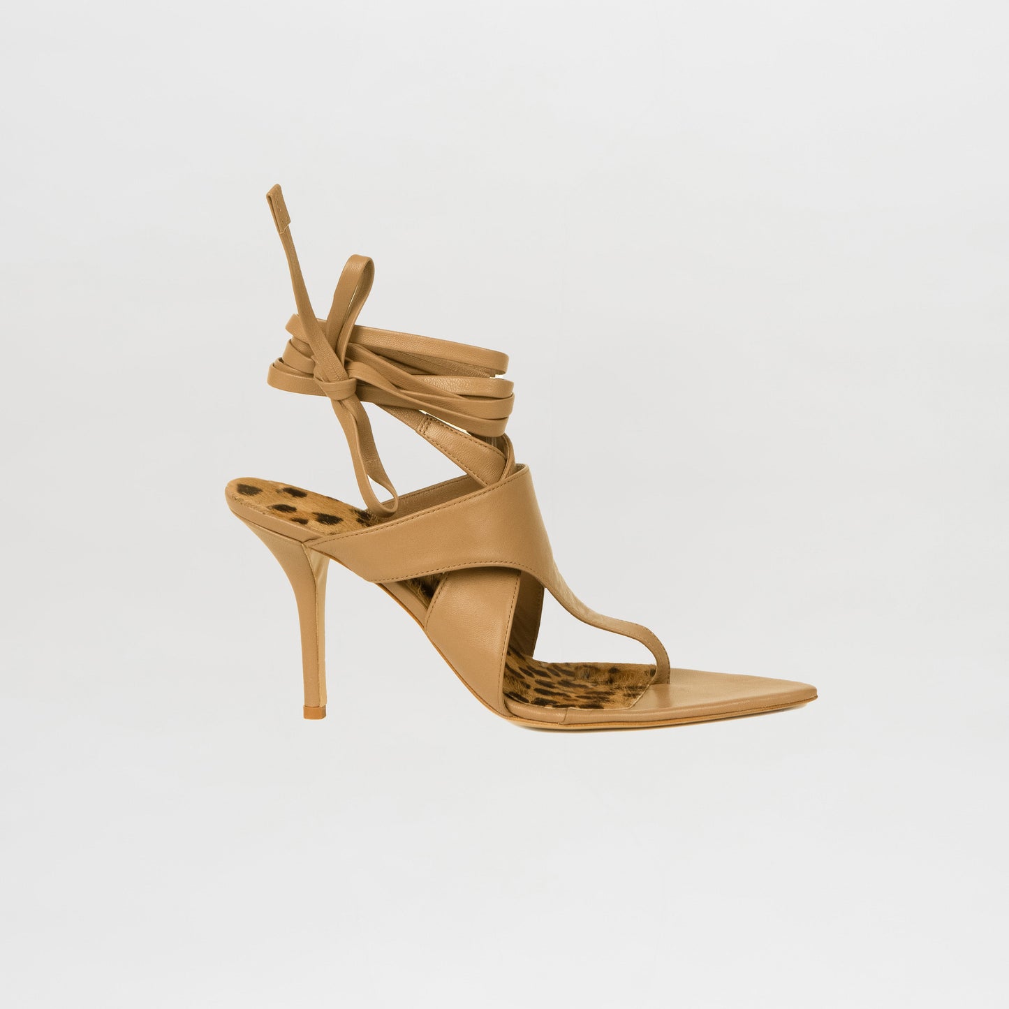 The Domenico Heels Taupe by GIA Couture are high-heeled sandals in tan Italian leather, featuring ankle wrap straps and a leopard print insole, shown against a plain white background.