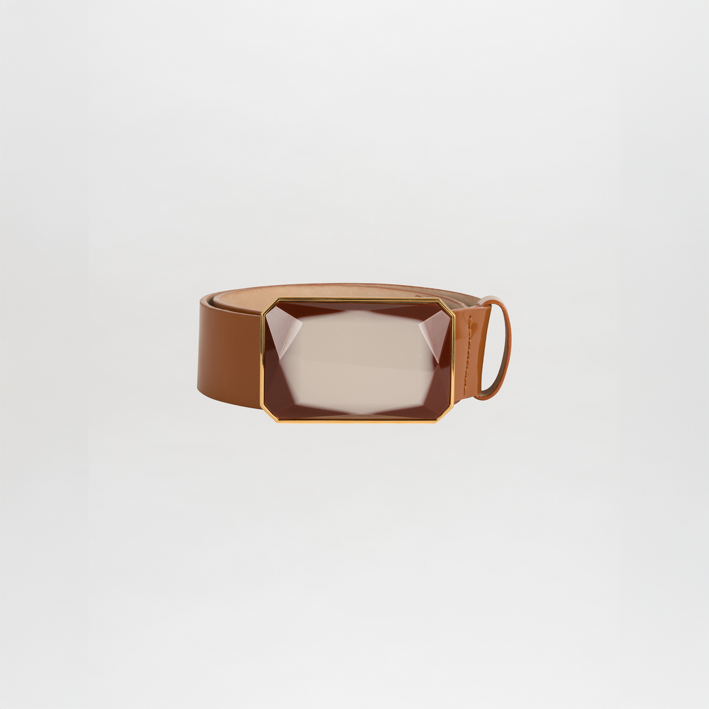 The Dora Belt, a brown leather belt with a large rectangular faceted buckle in a gold-tone frame, is ready to ship and is displayed against a plain white background.