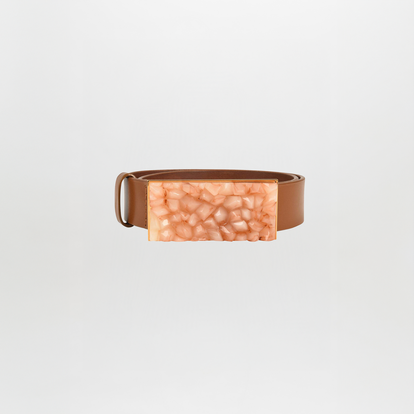 Make a statement with the Dora Belt Tan, a brown leather belt featuring a large rectangular buckle with a textured, peach-colored finish.