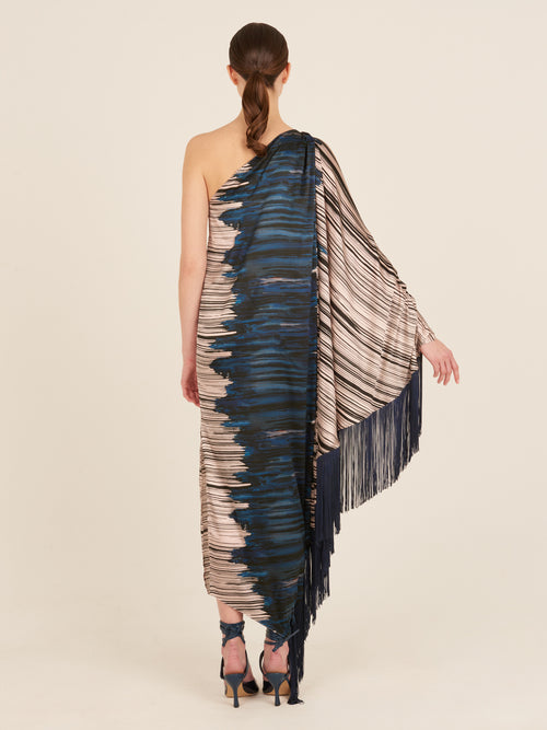 A blue and white fringed Alana Dress Indigo Linear, part of the Fall 2023 collection, is displayed on a mannequin with navy-blue fringes.
