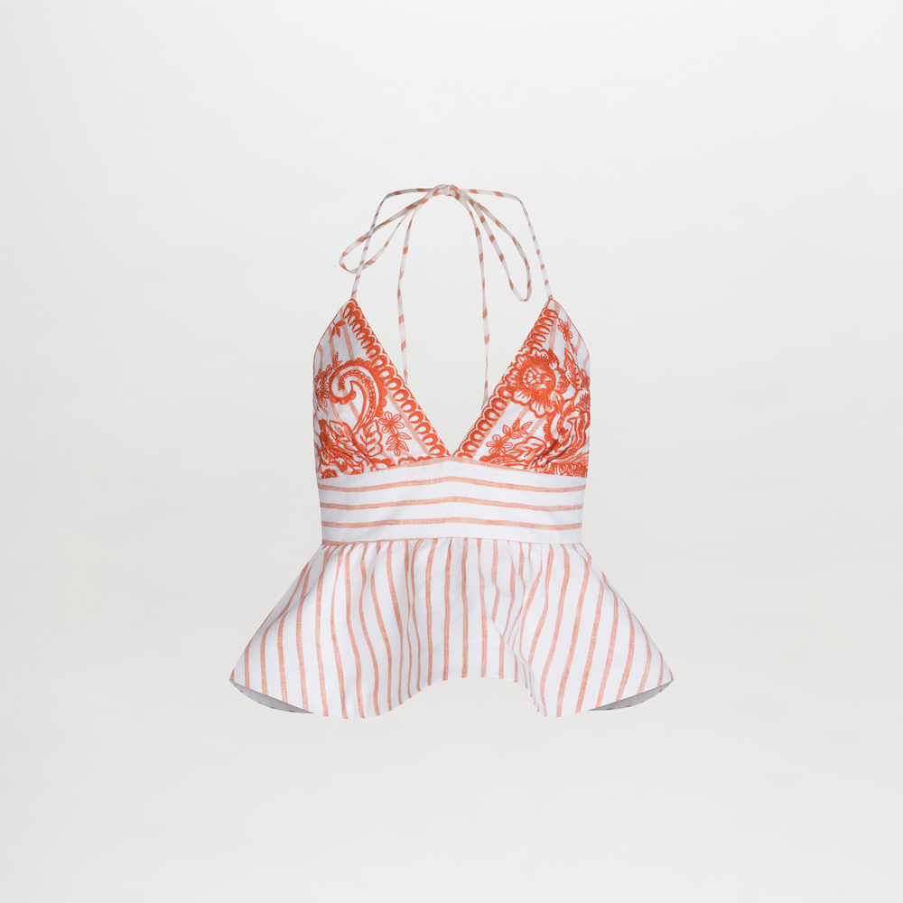 The Fabiola Blouse is a sleeveless halter top featuring embroidered paisley, vibrant orange accents, vertical stripes, and a peplum effect at the waist with elegant neck ties.