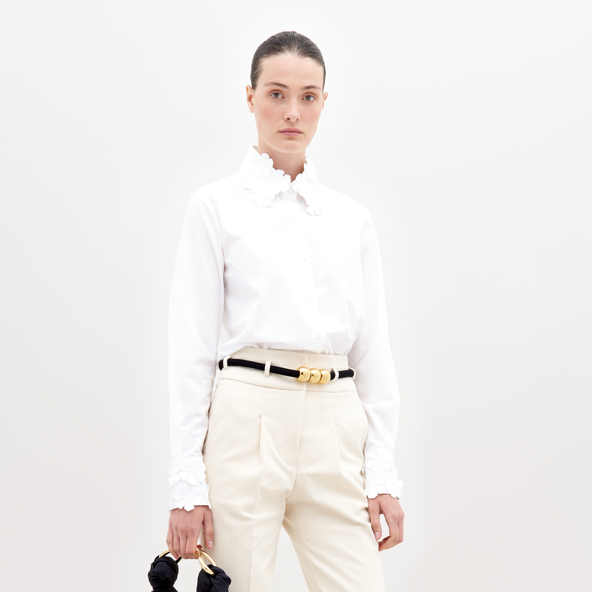 white blouse with gold accents