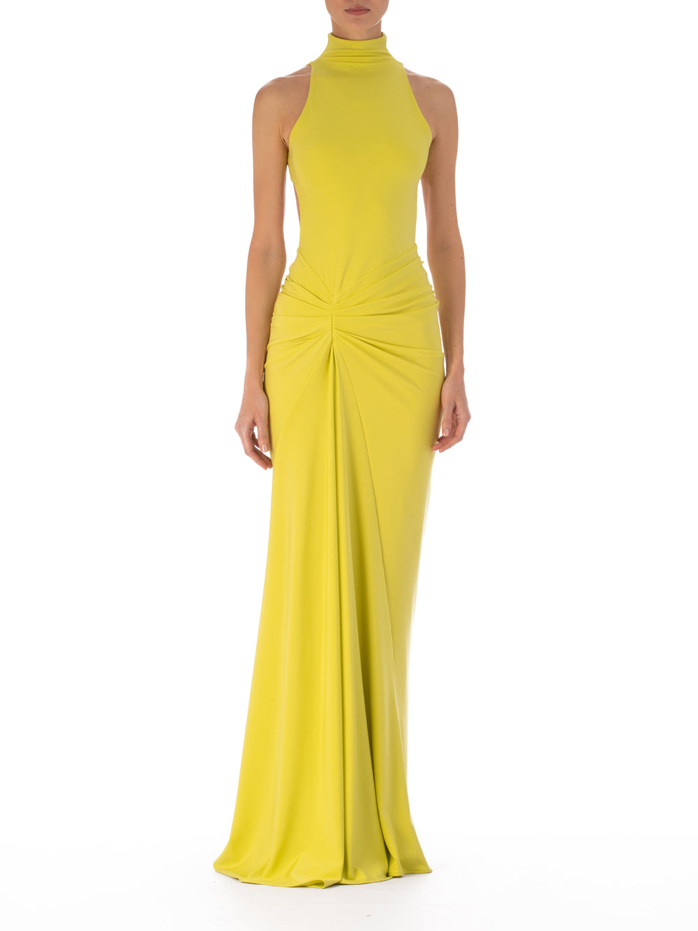 A person wearing the Frances Dress, a sleeveless, high-neck, floor-length yellow maxi dress with an asymmetric waistline and gathered detailing, stands against a plain white background.