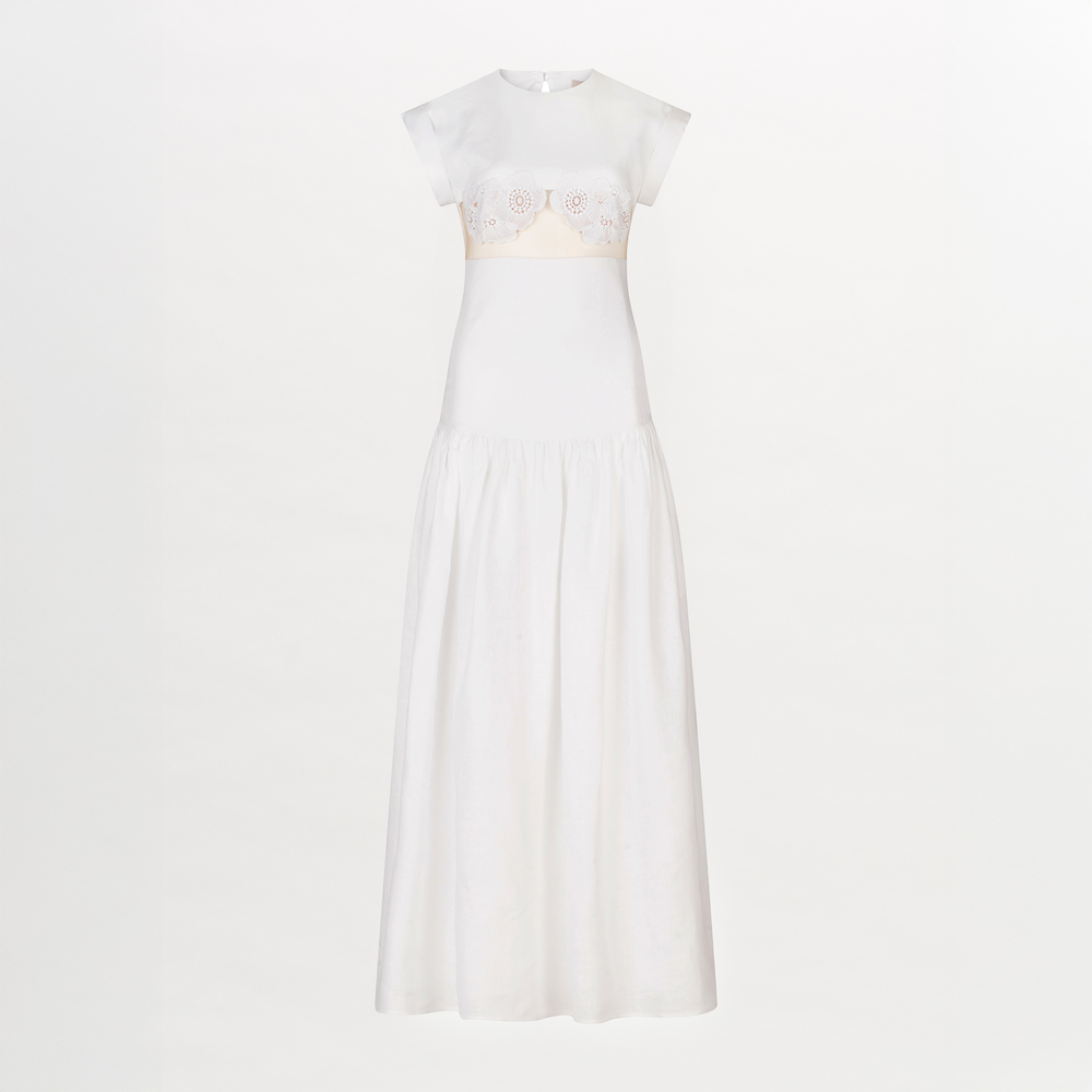A Hanane Dress White with lace trim and a fitted silhouette.