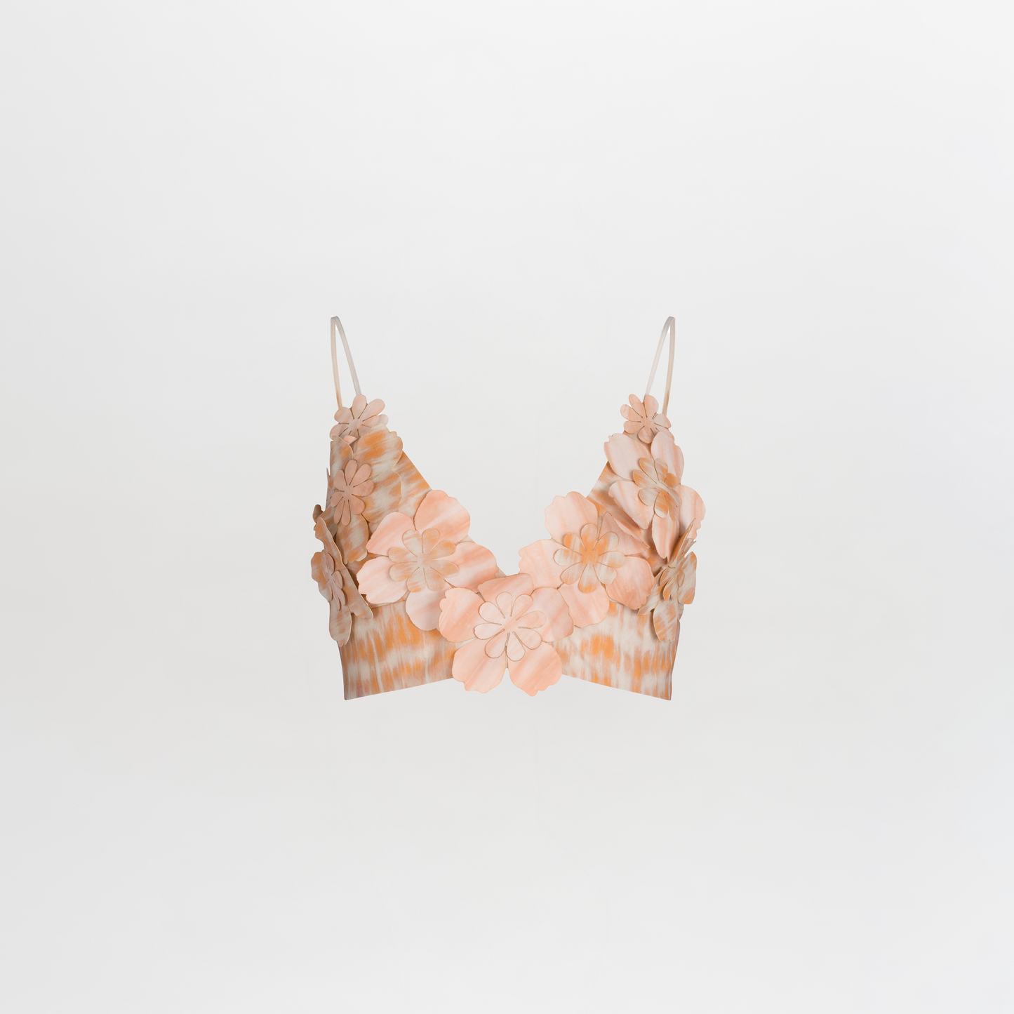 The Ibbie Top Mediterranean Coral Blue is a crop top bralette with spaghetti straps, showcasing exquisite floral detailing and 3D flower embellishments in soft shades of peach and beige on a plain white background.