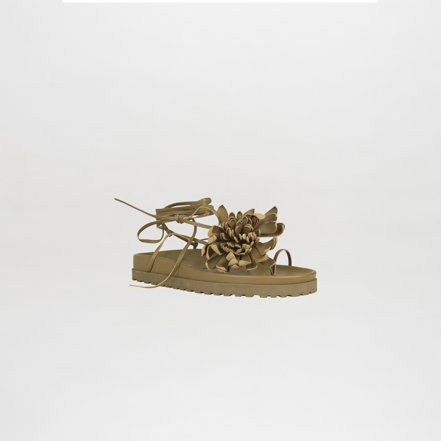 Beige sandal with floral design on a light gray background