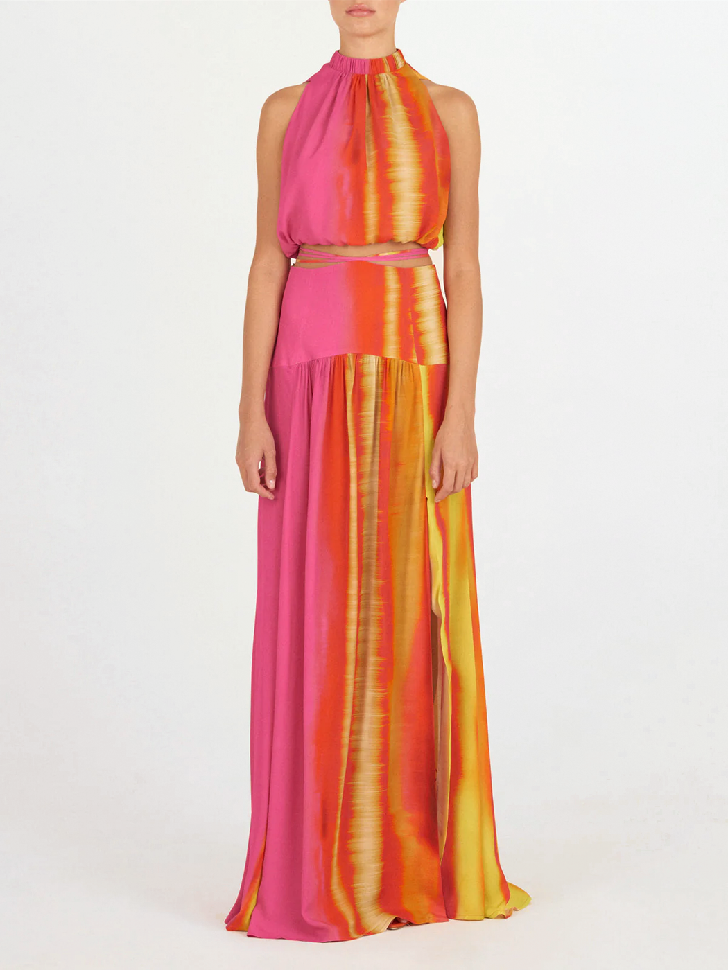 A colorful, balloon-style skirt with a vibrant pink, orange, and yellow tie-dye design, featuring an elastic waistband and hem—a timeless selection that pairs perfectly with the Leire Blouse Fuschia Lime Stripes.