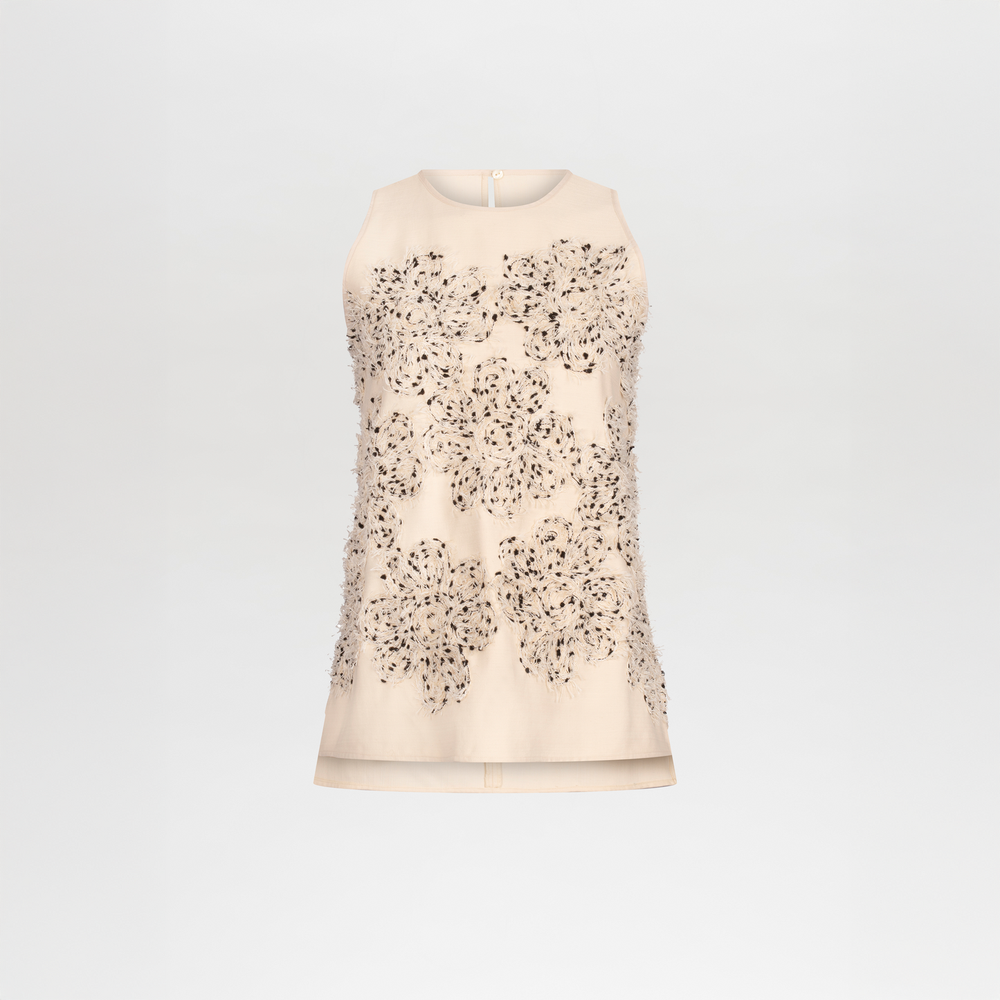 Sleeveless beige Leonora Blouse made from fine Italian textile, adorned with a large front flower appliqué featuring sequin and bead embellishments, shown on a plain white background.