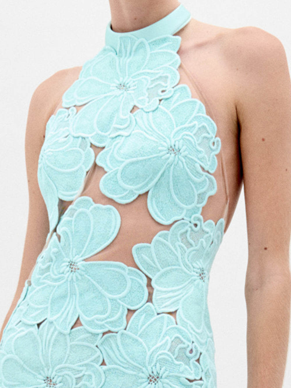 A person wearing the Mab Dress in color Turquoise on a white background.