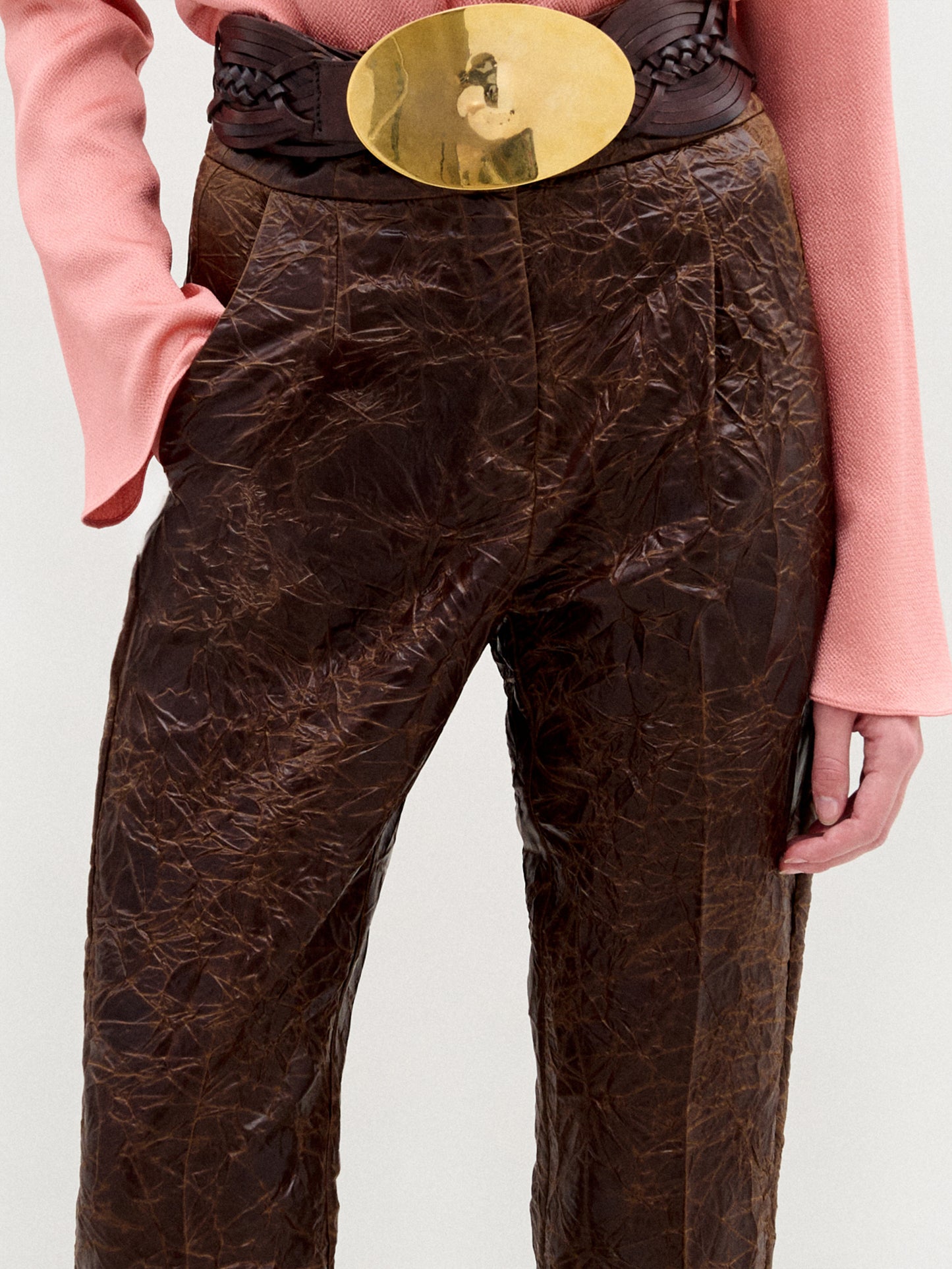 A person stands against a plain background wearing the Moad Pant, a high-waisted cropped style with a straight fitted leg made from Italian fabric.
