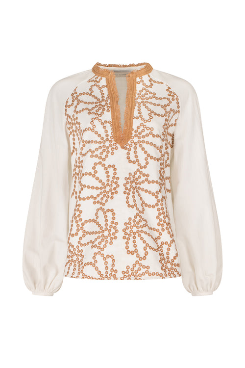 A Molveno Blouse White Cacao Eyelet with orange embroidery and lace detailing.