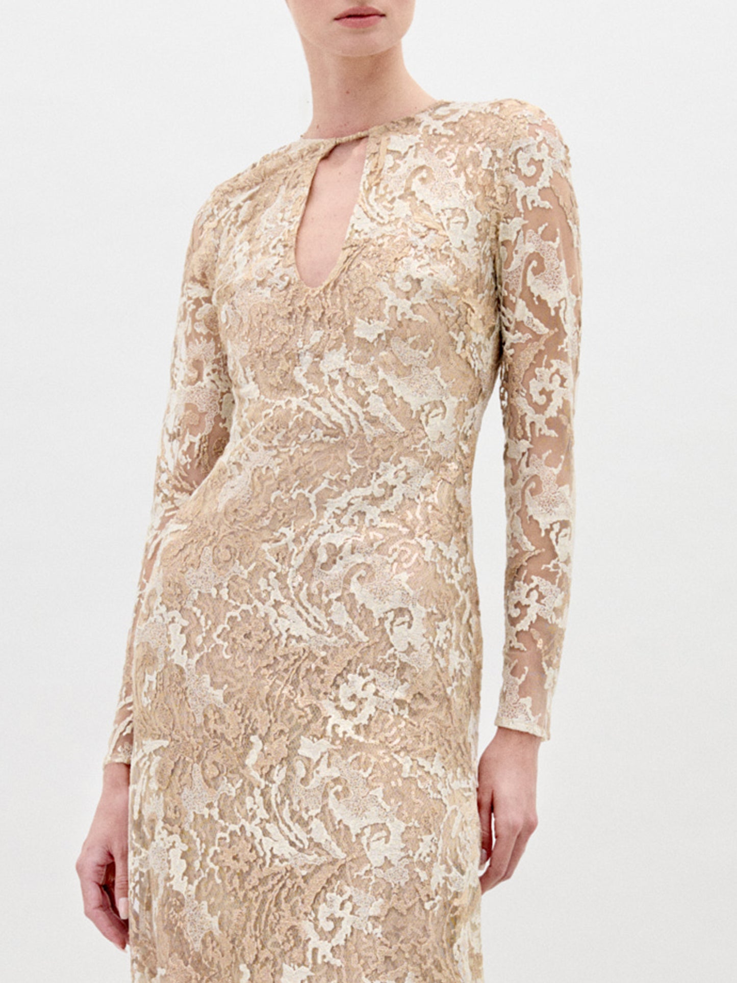 A person stands against a plain background wearing the Nila dress