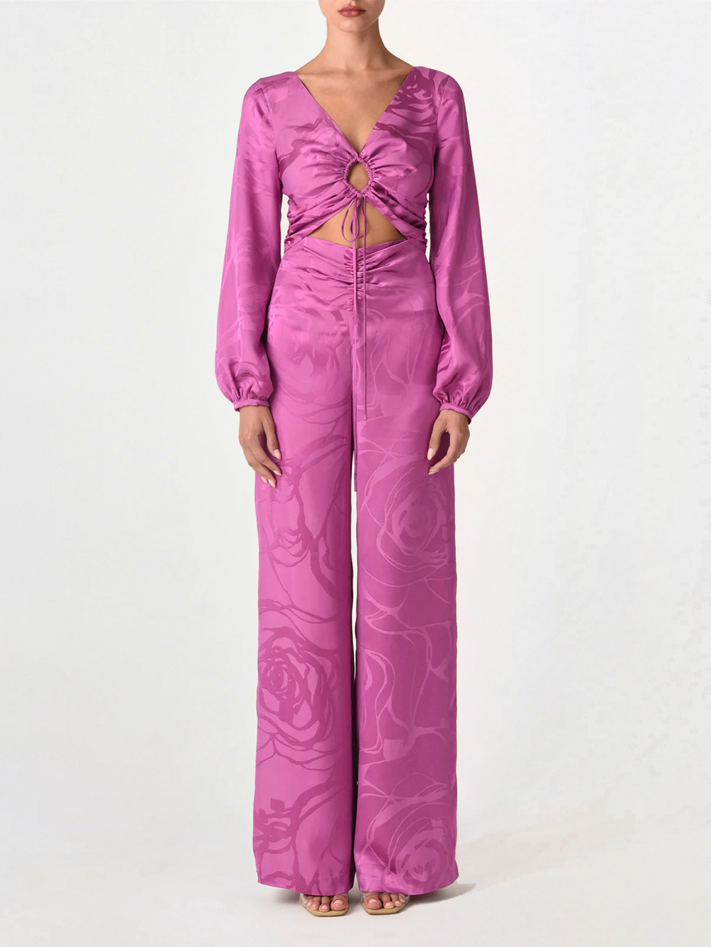 A magenta orchid jacquard, cropped, long-sleeved Odette blouse with a tie-front design and an abstract print, isolated on a white background.