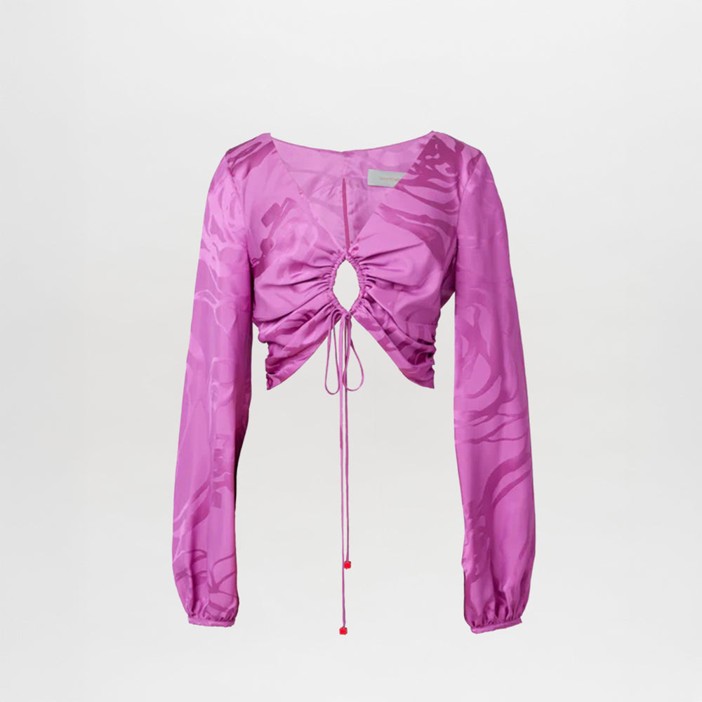 A magenta orchid jacquard, cropped, long-sleeved Odette blouse with a tie-front design and an abstract print, isolated on a white background.