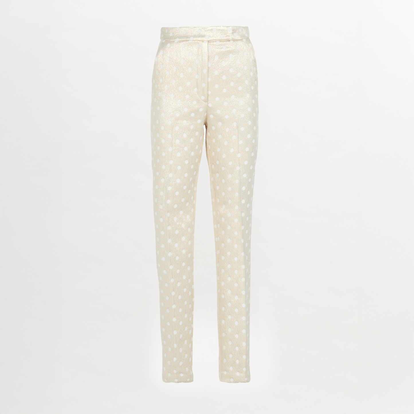 Rear view of a person with long hair in a ponytail, wearing a white blouse and the Orion Pant Gold Inverted, featuring high-waisted trousers with a straight leg silhouette, standing in heels on a plain background.