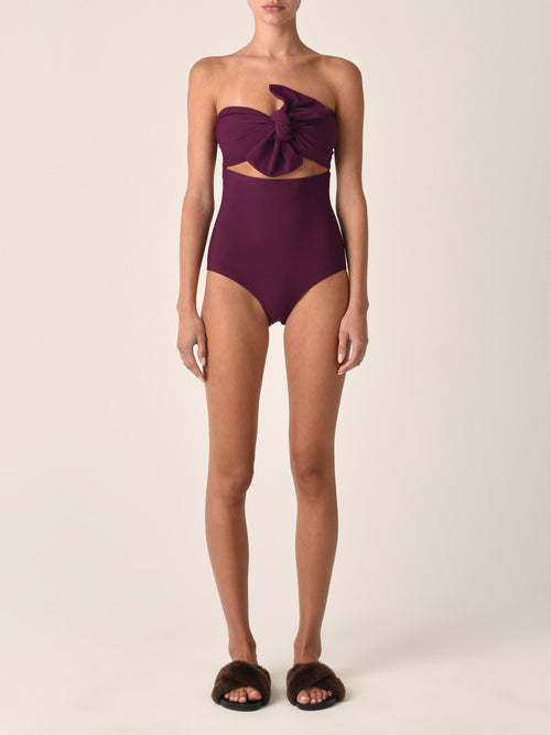 Costanzo One Piece Plum swimsuit with a cut-out design and a Silvia Tcherassi bow detail at the bust.